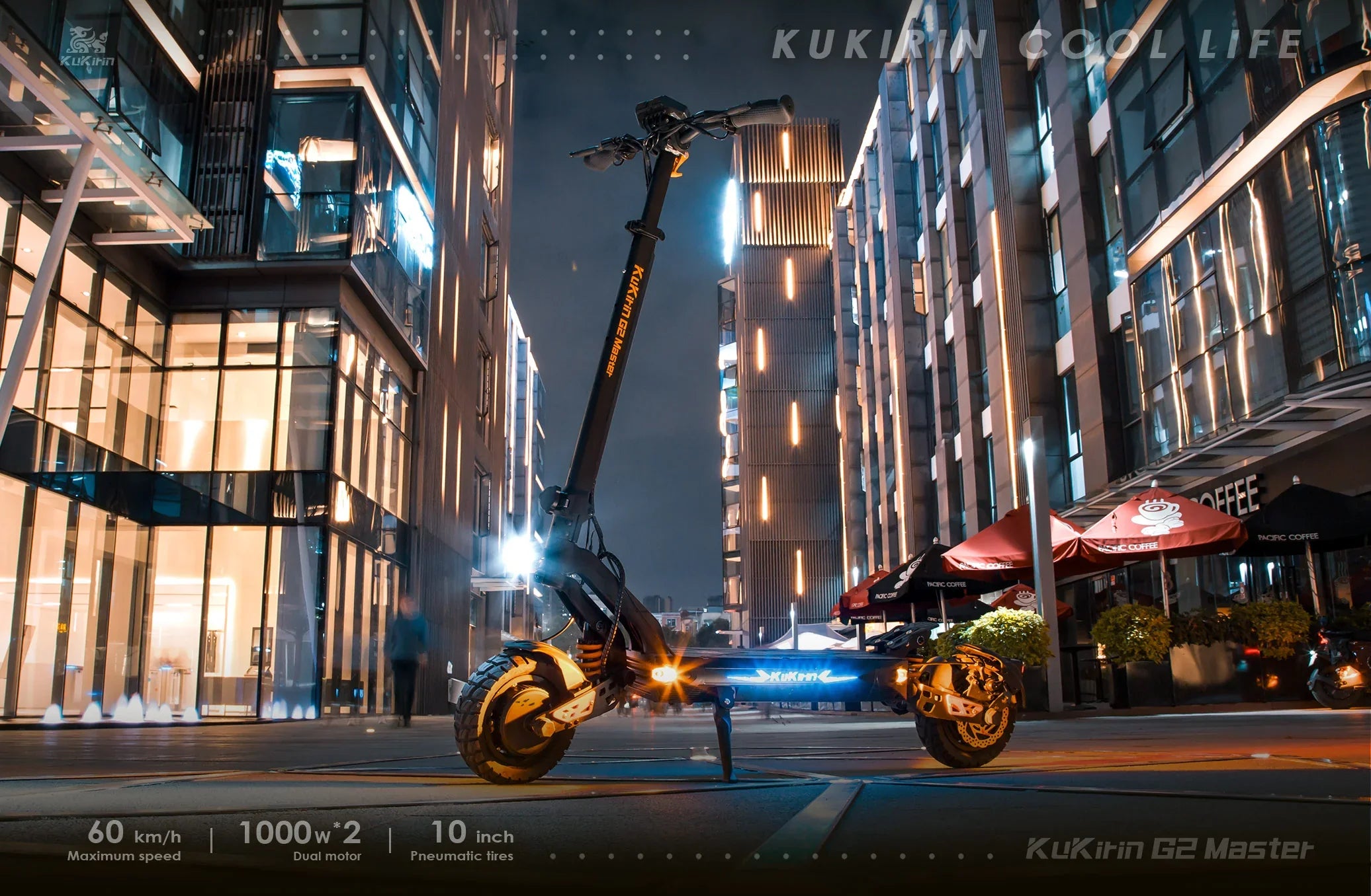 KuKirin electric scooter paarked in a modern city street at night.